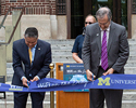 U-M executive leadership cut a ribbon on the steps of Hatcher Graduate library to celebrate WiFi on the Diag
