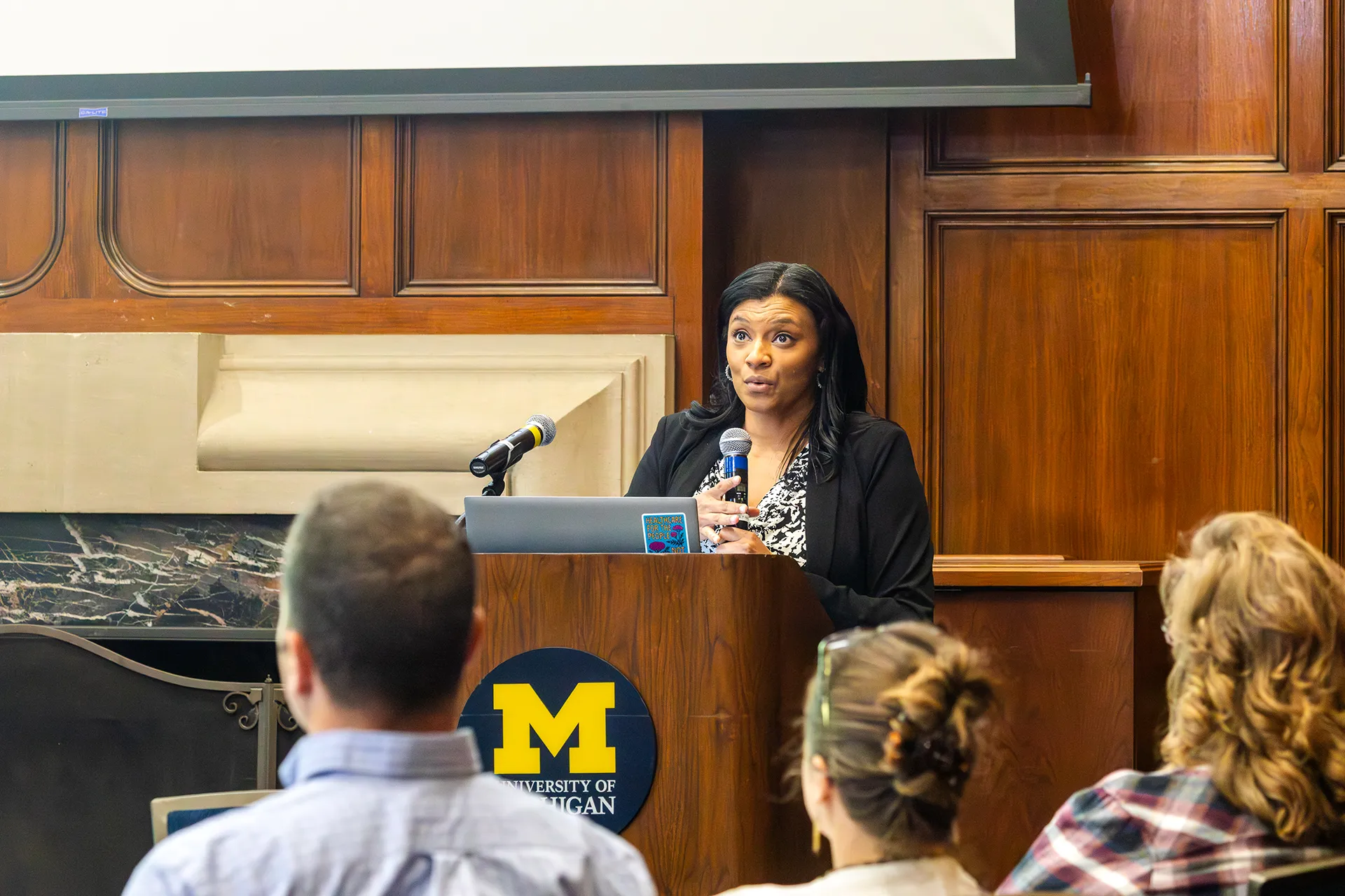 Alena Williams, Wellness Program Manager at MHealthy, at the podium leading a conference working session