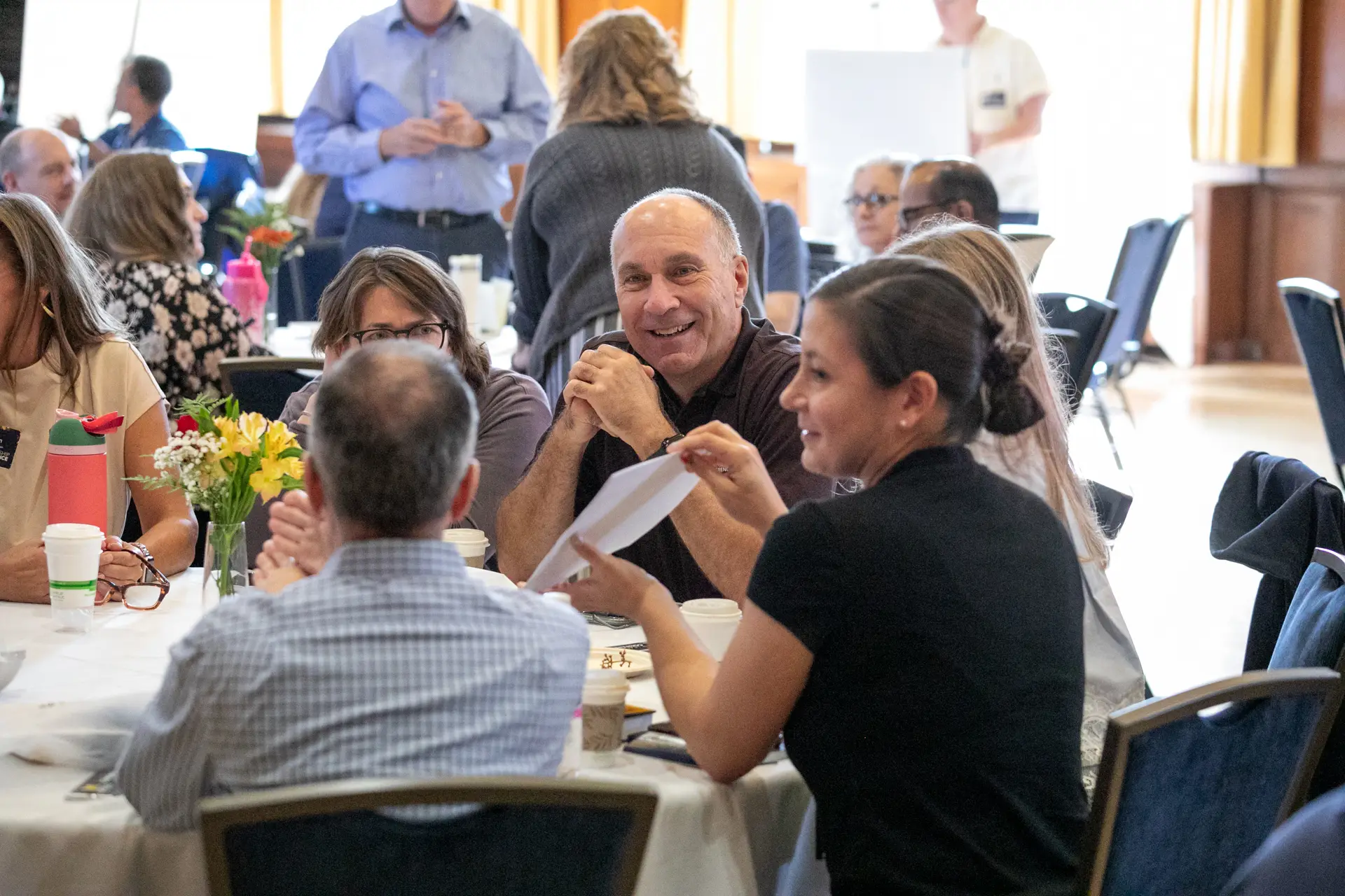 Attendees having a discussion around their table.
