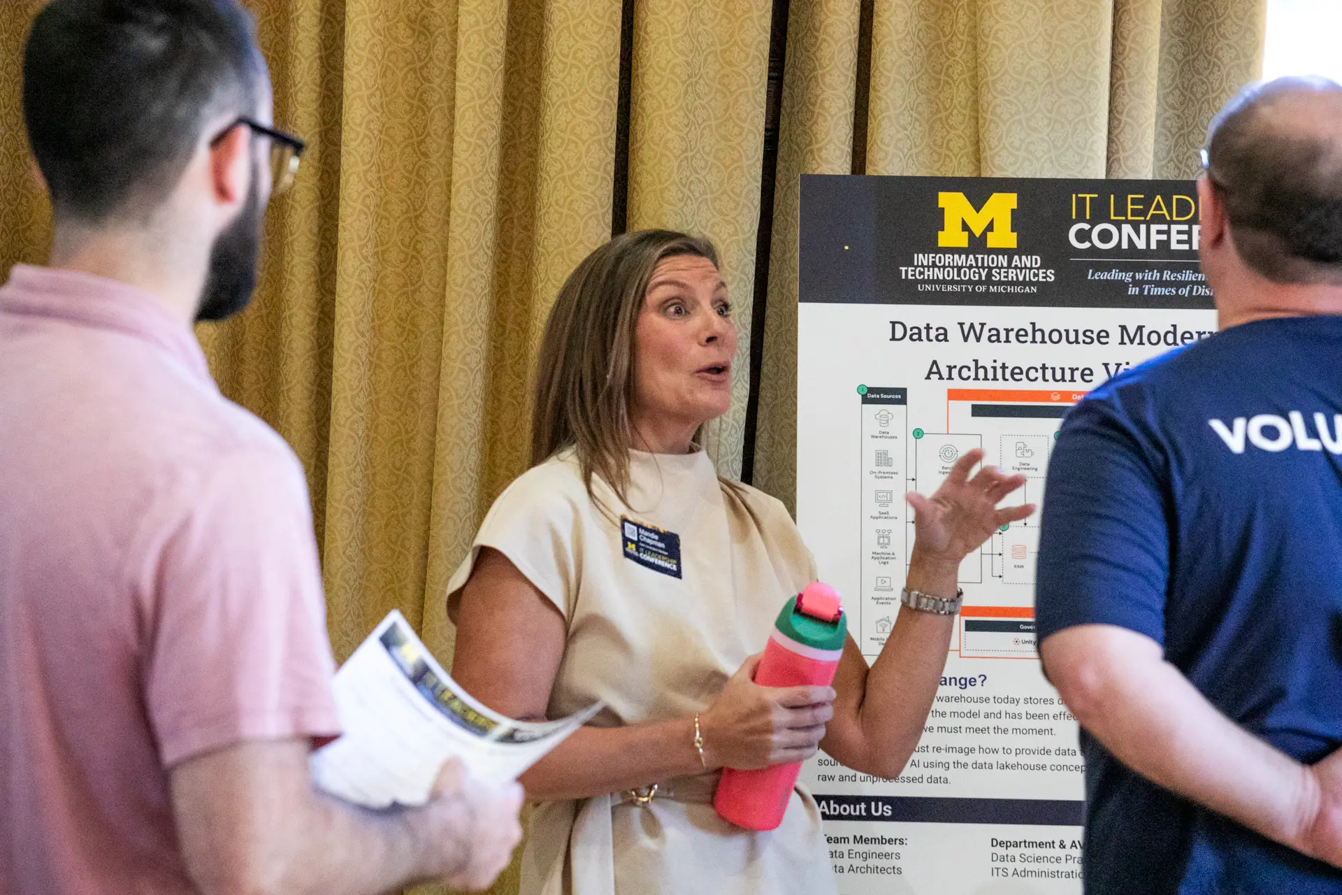 Attendees having a discussion during the poster presentation.