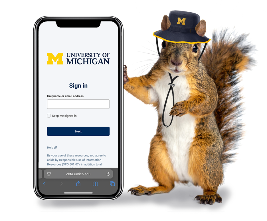 A squirrel wearing a University of Michigan hat stands next to a phone showing the U-M Okta sign-in page.